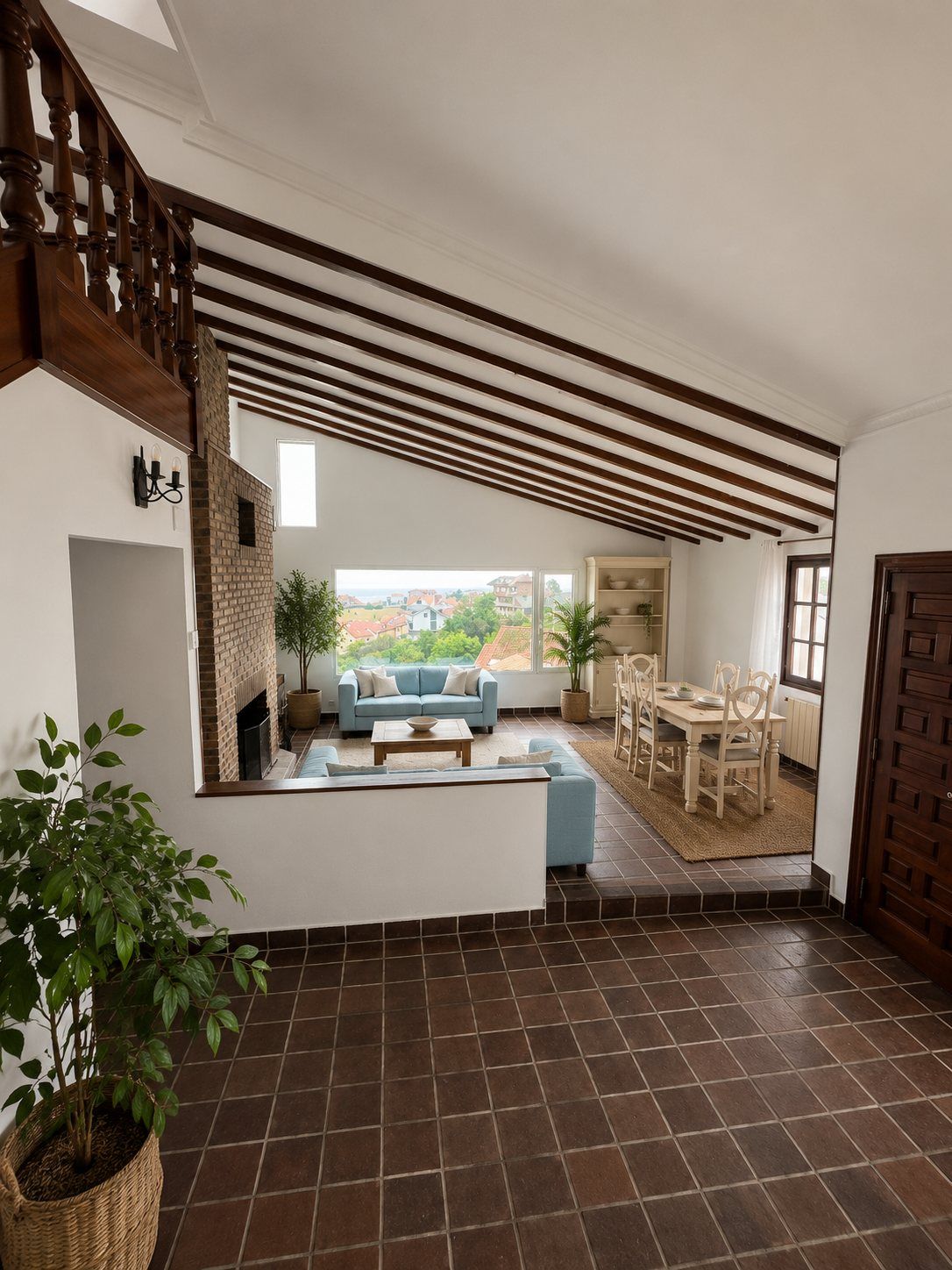 The living and dining room, with a wood-beamed ceiling and a staircase to the upper floor.